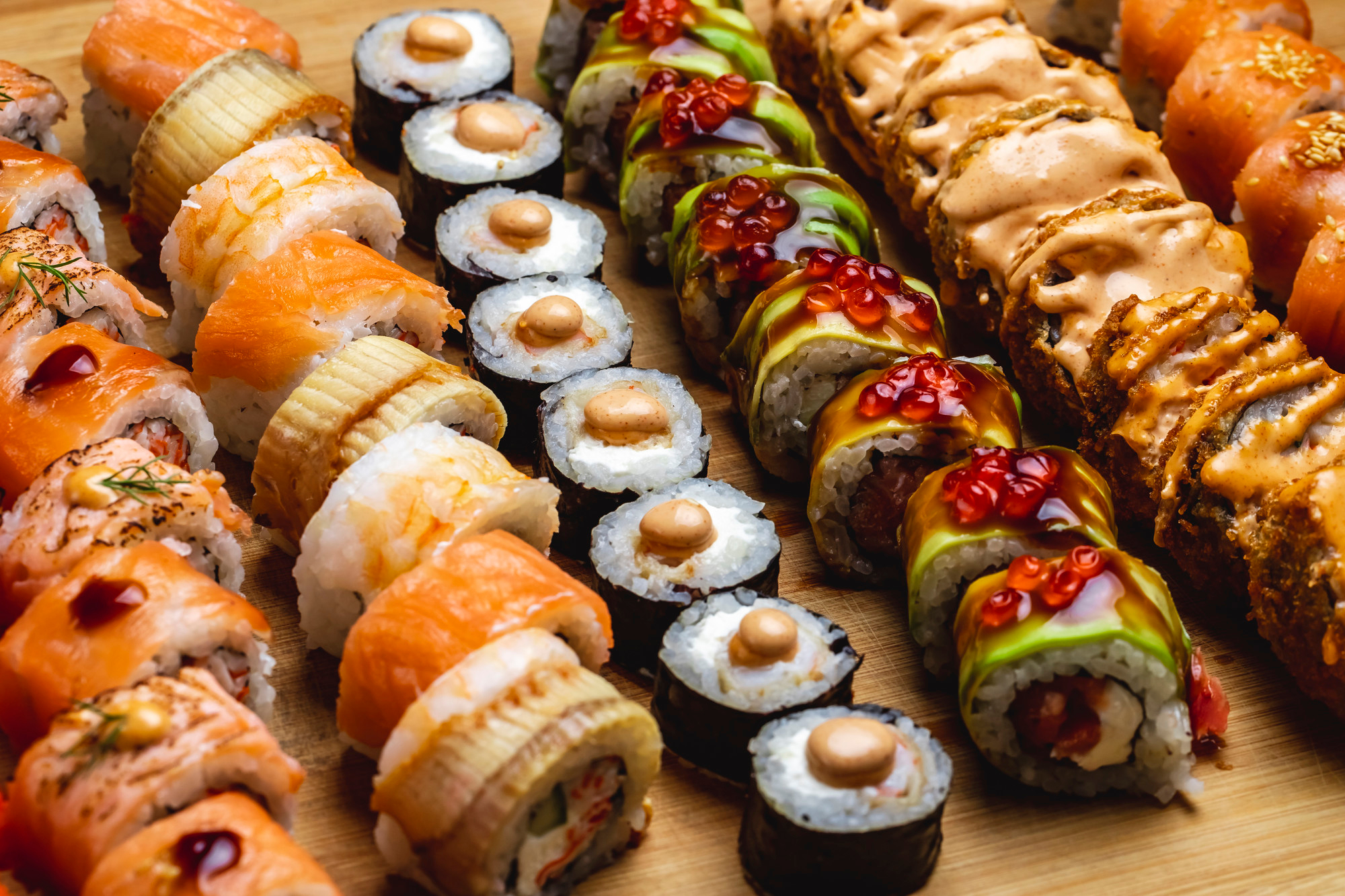 side-view-sushi-set-philadelphia-roll-with-salmon-conger-ell-maki-dragon-roll-hot-roll-board(1)